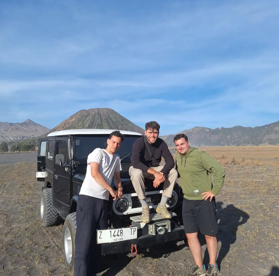 Scenic view of Kawah Ijen volcano at sunset with colorful sky and crater lake